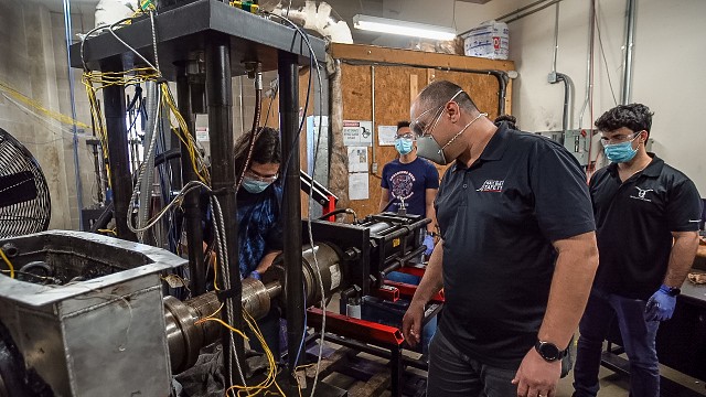 Dr. Constantine Tarawneh and UTRGV students install a bearing in the bearing testing lab at the UTRGV Engineering Building in 2020.