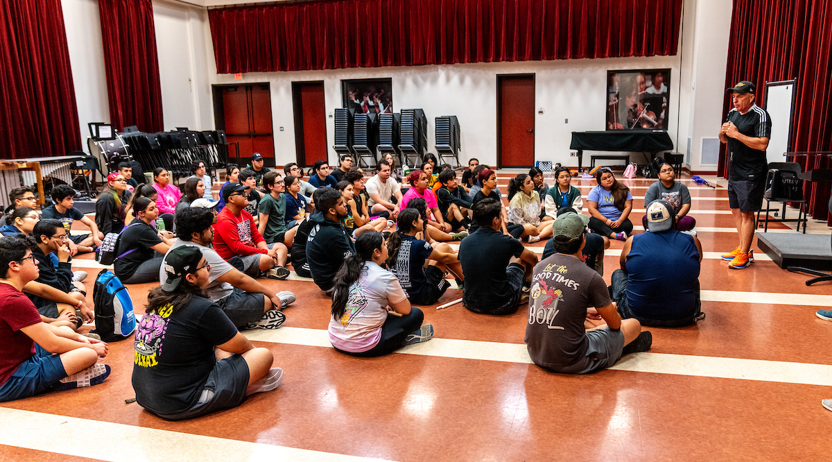 utrgv students during marching band practice with band director