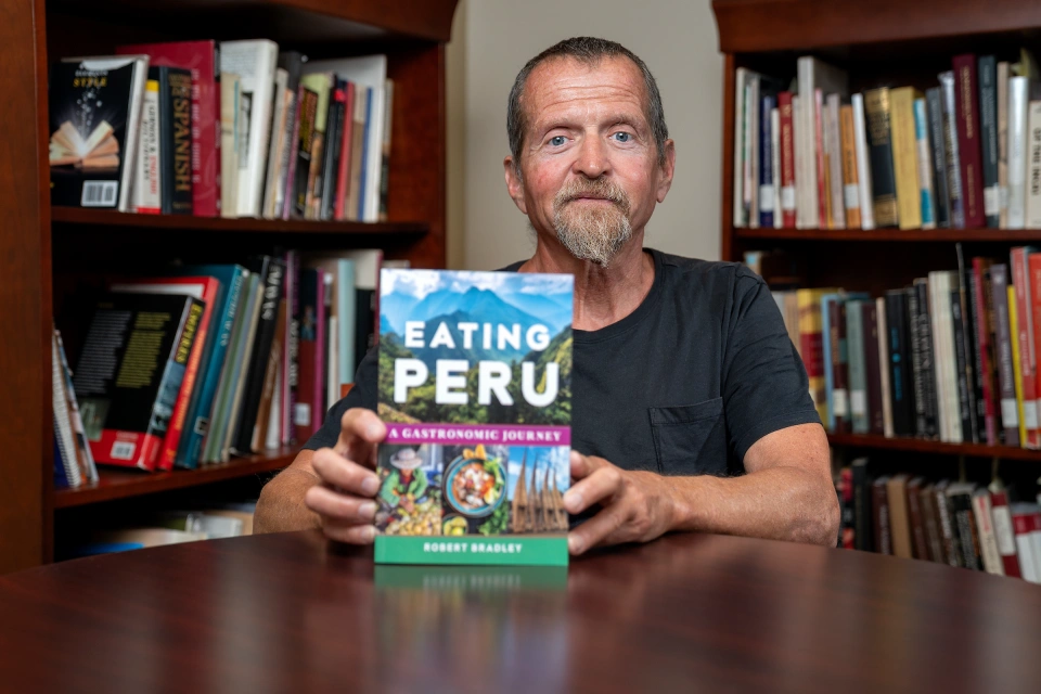 Dr. Robert C. Bradley holding copy of book