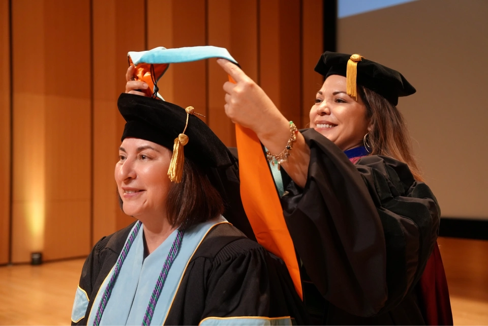 Spring 2024 doctoral candidate Dalila Ochoa is hooded by Dr. Joy Esquierdo, during the doctoral hooding ceremony, May 8, 2024, at UTRGV Performing Arts Center on the Edinburg Campus. (UTRGV Photo by Jesús Alférez)