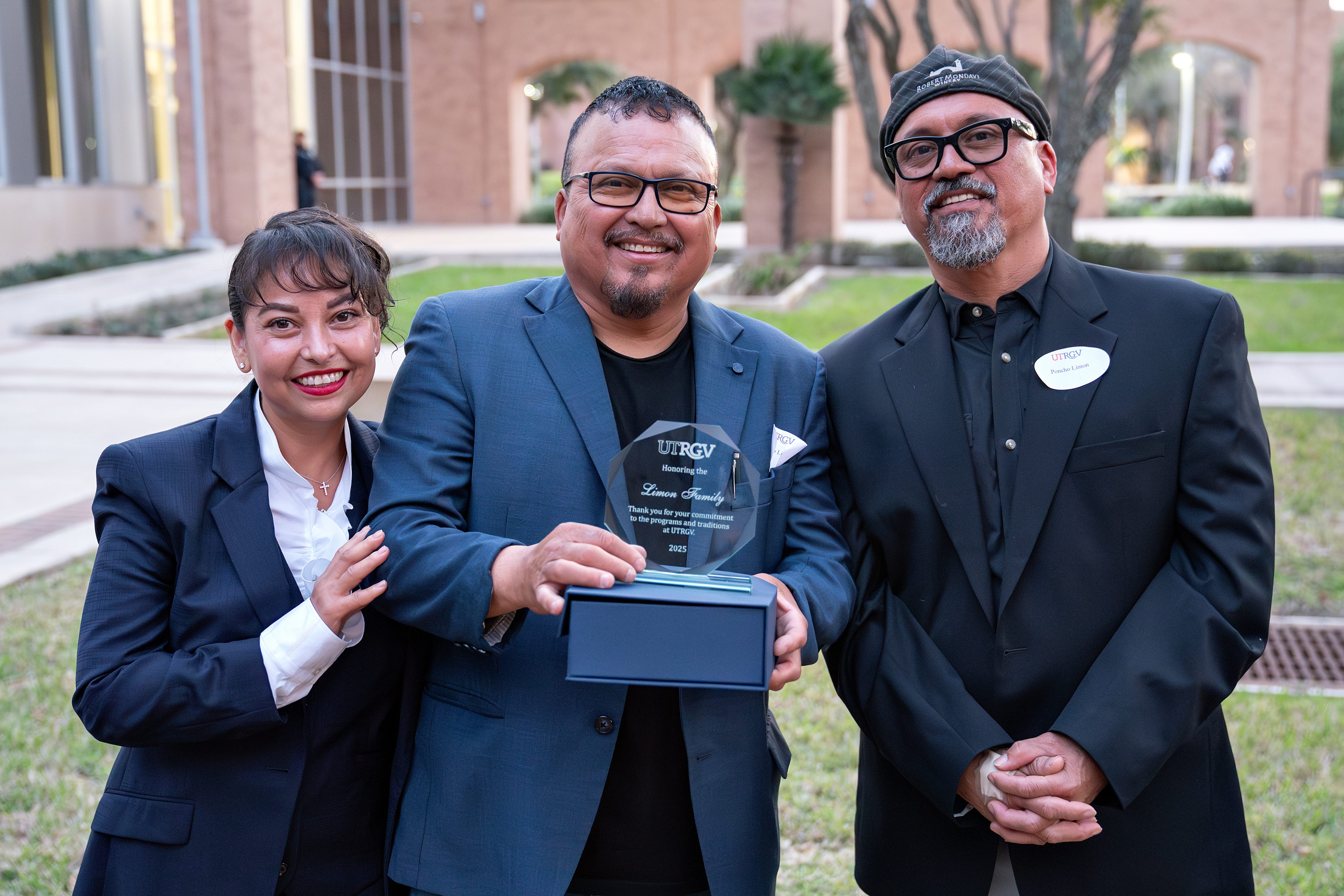 Katty Limon, Rolando Limon holding the glass plaque and Poncho Limon
