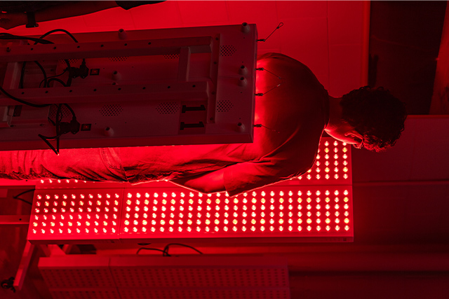 A guest stands in one of the lab’s light arrays in Room 117A of the Health and Physical Education Building II (HPEII) on the Edinburg Campus