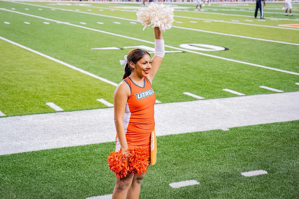 UTRGV Cheerleader Madi Velasquez on the football field 