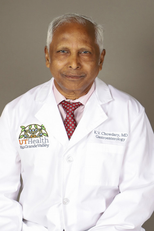 Man with gray hair in a white lab coat and red tie, smiling gently. The coat reads "UT Health Rio Grande Valley" and "Gastroenterology."