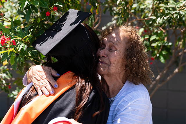 A graduate shares an emotional moment with a family member following Spring 2026 commencement ceremonies on May 15, 2026, at Bert Ogden Arena in Edinburg. The ceremonies recognize students from across The University of Texas Rio Grande Valley who completed their academic journeys this spring.