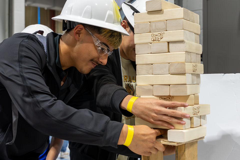 Students in jumpsuits participating in an activity ...