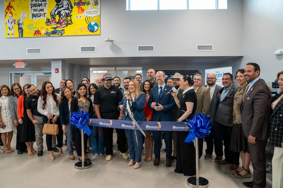 A group of people together during a ribbon cutting ceremony