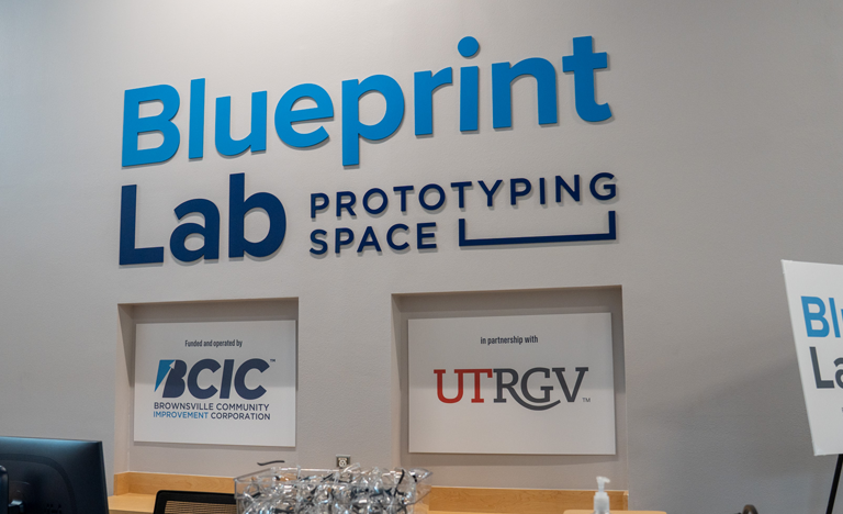Blueprint Lab signage on display on a white wall