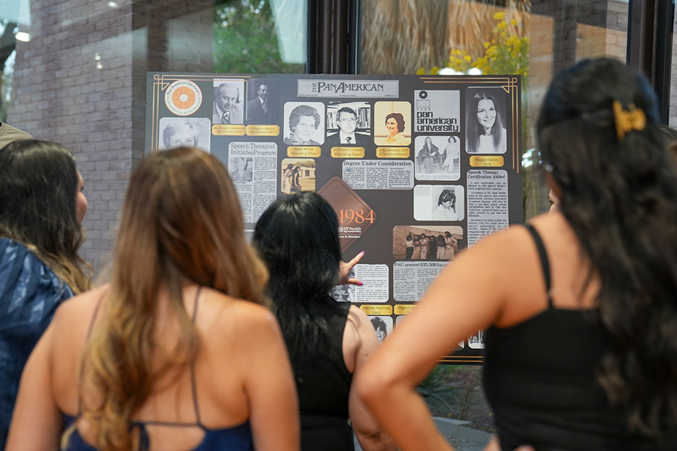 Alumni view a historical display during the UTRGV Speech & Hearing Center's 50th anniversary celebration.