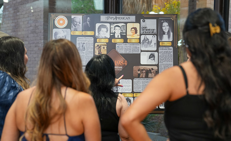 Alumni view a historical display during the UTRGV Speech ...