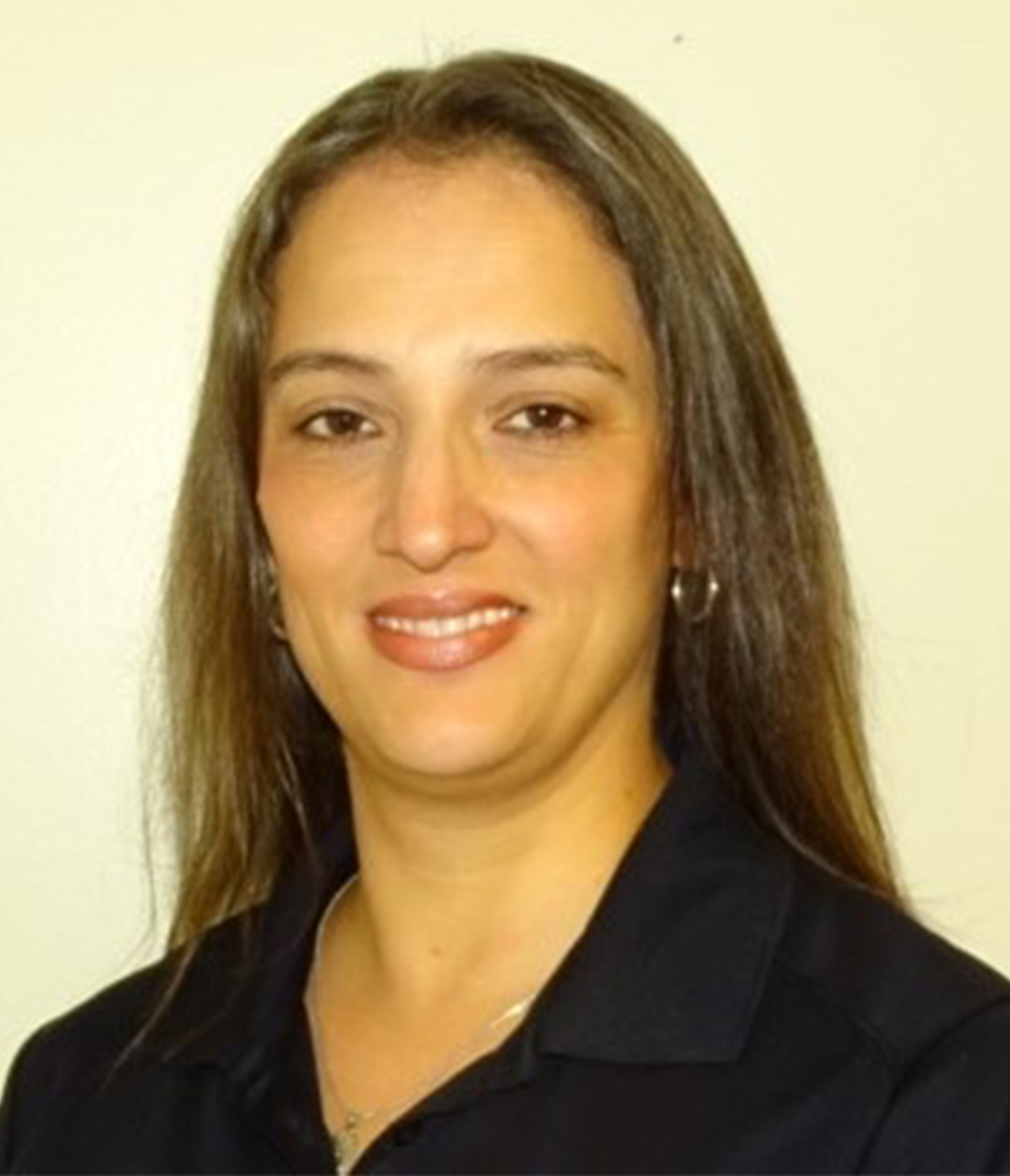 Professional headshot of Nancy Razo wearing a black collared shirt against a light-colored background.
