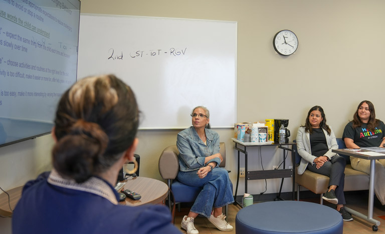 Group of people sitting in a classroom during a training ...