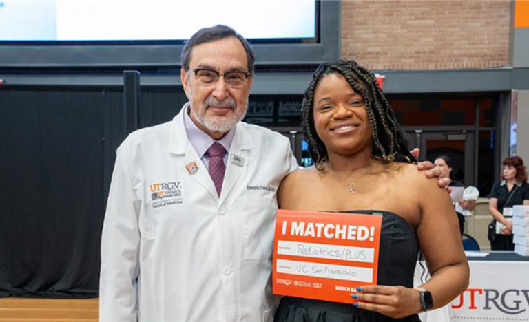 A smiling woman holds a "I Matched!" sign for ...