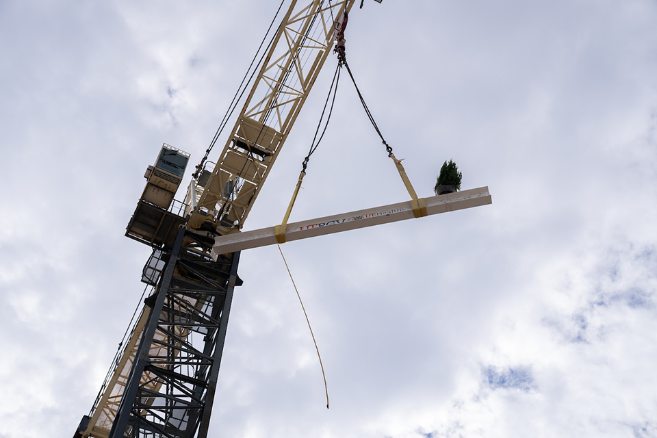 Metal beam raised by crane