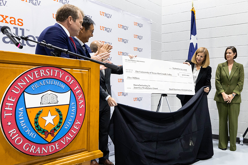 UTRGV and U.S. Small Business Administration representatives unveil a ceremonial $5 million grant check during a presentation supporting manufacturing growth in the Rio Grande Valley.