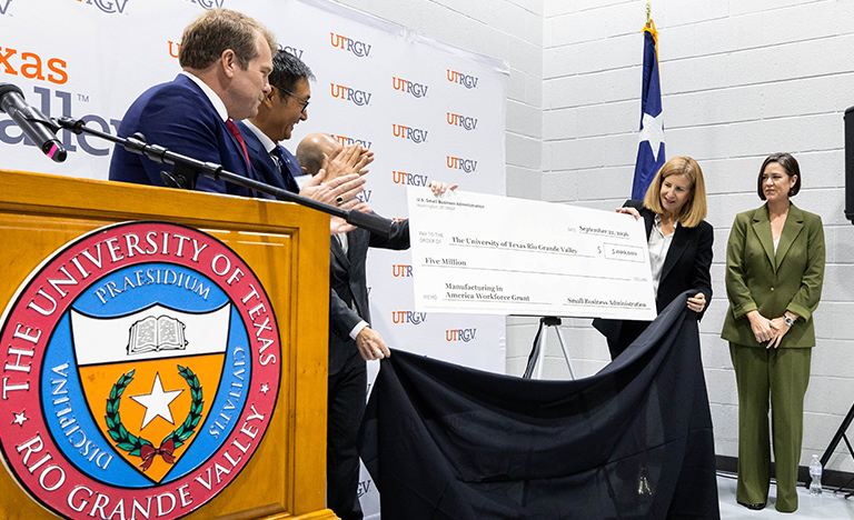 UTRGV and U.S. Small Business Administration representatives unveil a ceremonial $5 million grant check during a presentation supporting manufacturing growth in the Rio Grande Valley.
