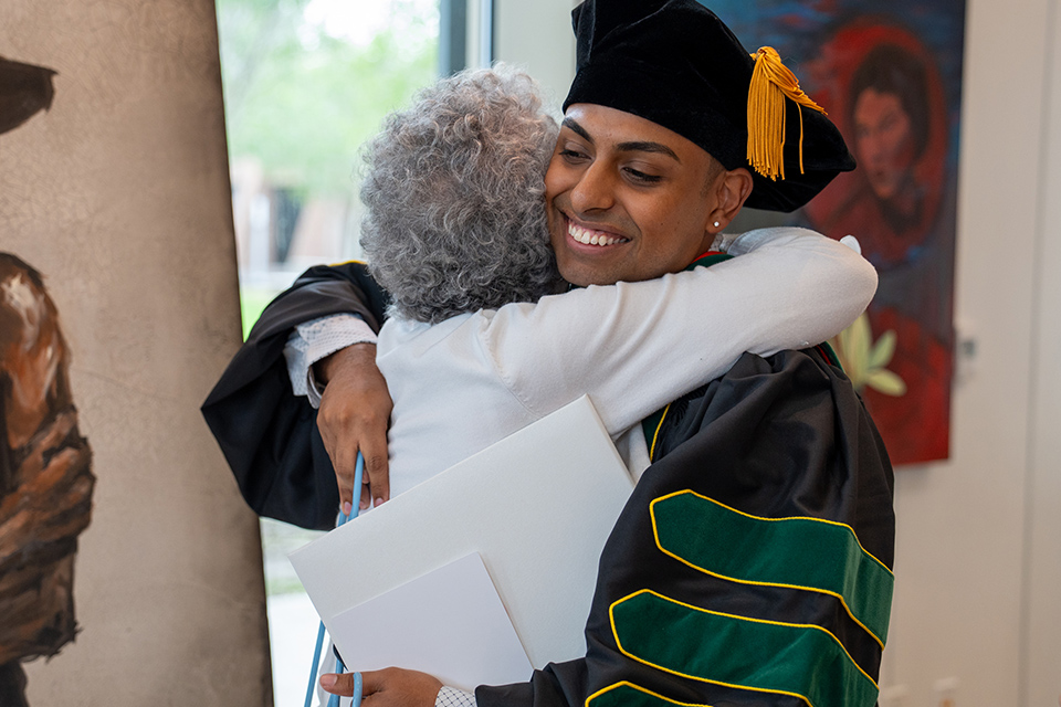 UTRGV School of Medicine graduate hugs a family member after the graduation ceremony on May 9, 2026.