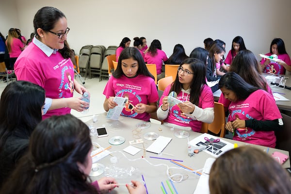 Adriana Olvera, UTRGV Engineering Technology Program Lecturer, helps high school students build balloon powered cars.