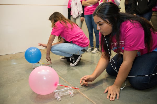 Female students from area high schools race their balloon powered cars.