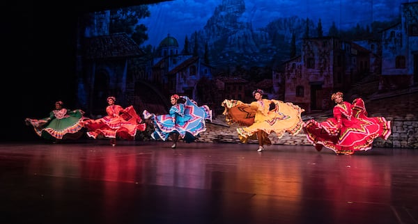 Folklórico dancers show off bright colored dresses in a typical dance.