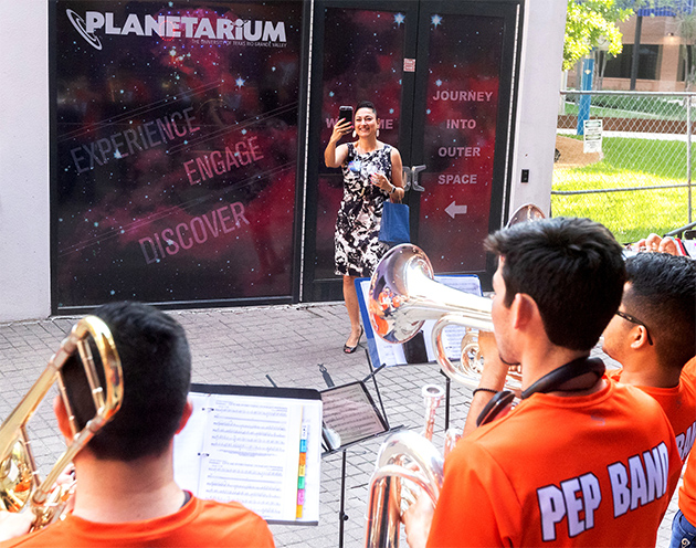 Yvonne Loflin representing H-E-B, shooting video of the UTRGV Pep Band. 