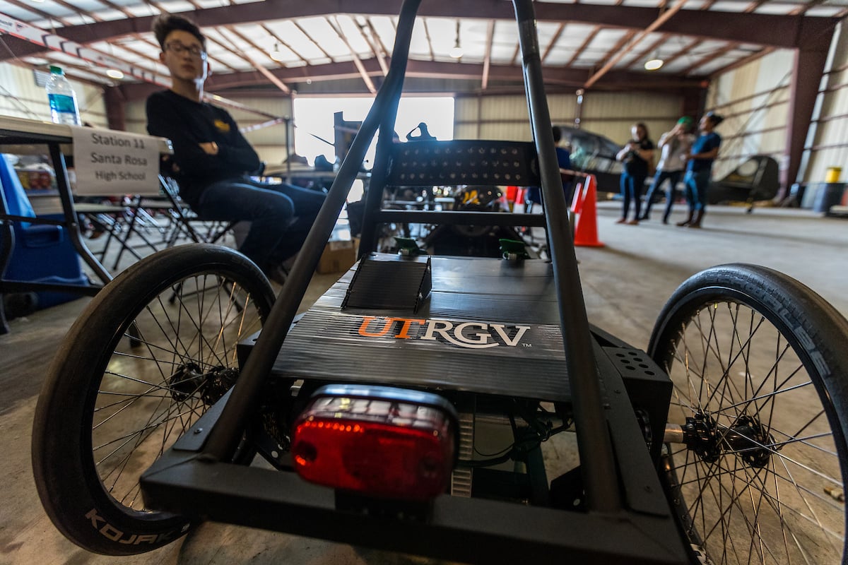 Contestant looks at his battery powered vehicle.