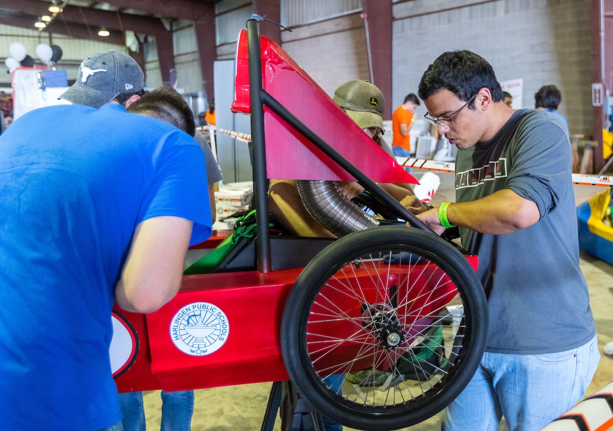 Harlingen Public Schools team works on thier electric cart.