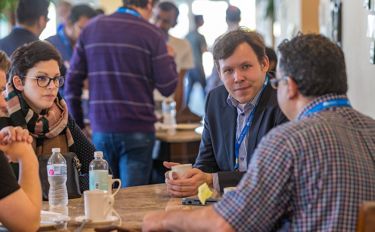 Attendees chat during a break at the Data Intelligence and Security Conference.