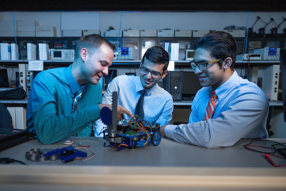 UTRGV students Samuel Roberts, Joshua Acosta, and Salvador Garza with the robot they built for the IEEE Region 5 Robotics Competition.