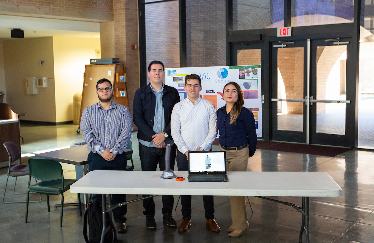 Four CETYS University students posing for the poster session.