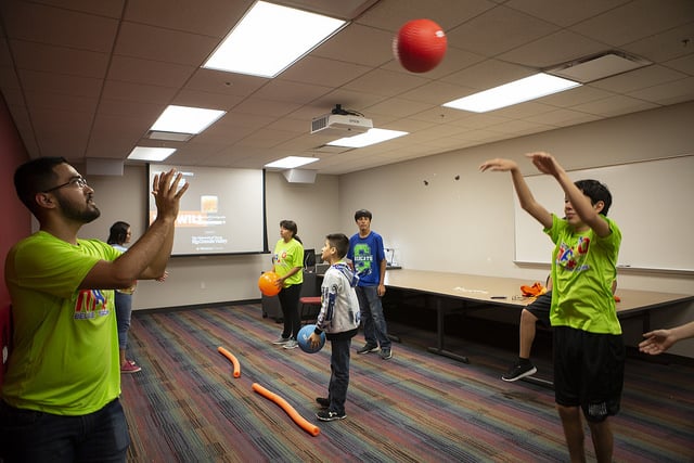 Team Mario summer camp participants play with a red ball.