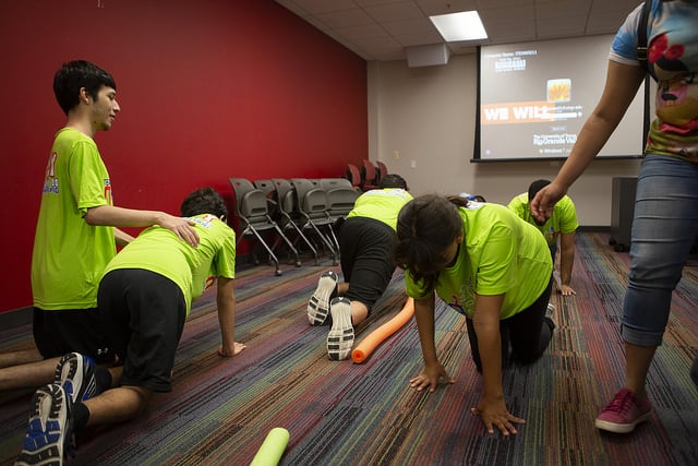 Thumbnail: Team Mario summer camp participants crawl on the floor during an exercise.