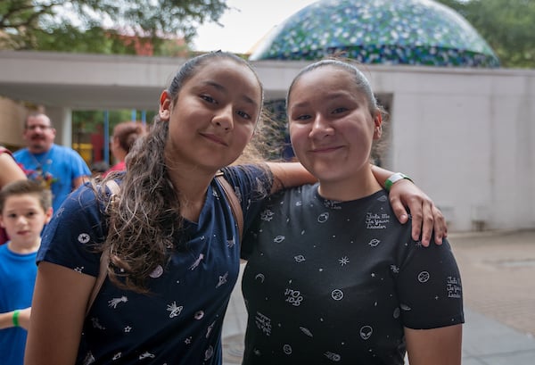 Thumbnail: In this image, Madeline, left, and Hailey wait in line to enter the H-E-B Planetarium.