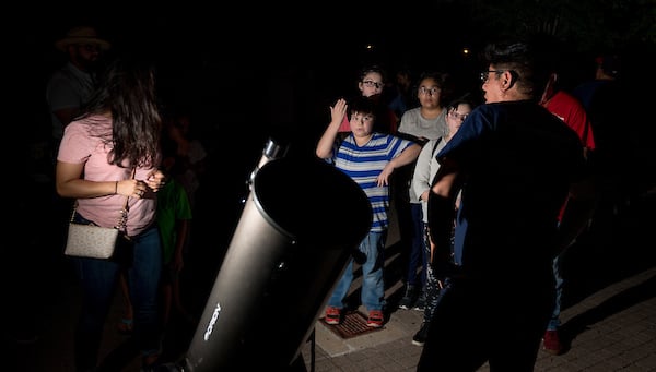 Children waiting for thier turn to see Venus, Saturn, Jupiter and the Moon through a powerful telescope.