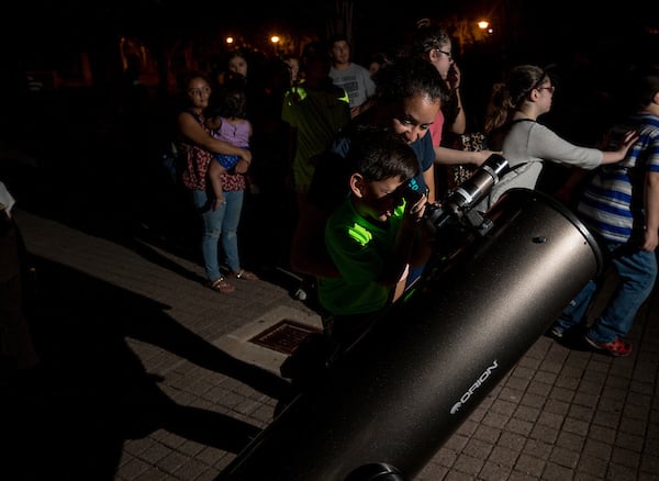 Child looking thru the telescope.