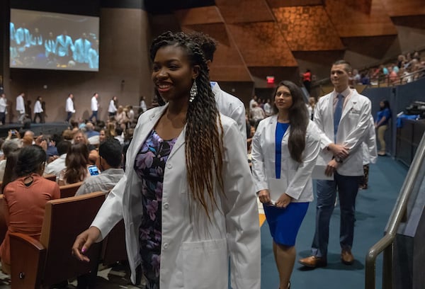 Students exiting White Coat Ceremony