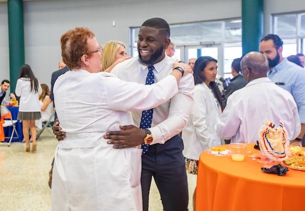 Professor congratulating student.