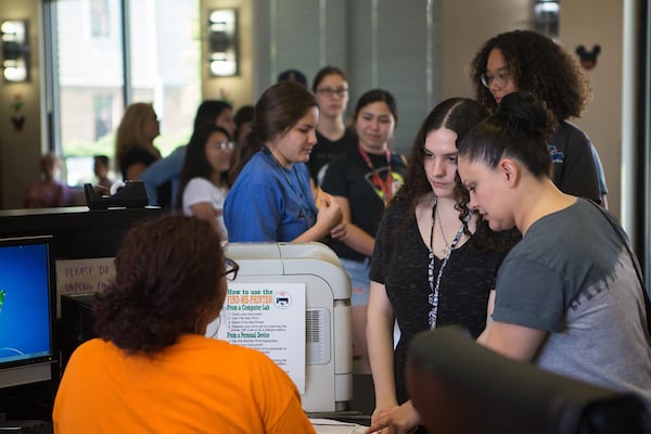 Freshman is oriented at counter on move-in day.