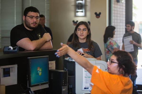 Freshman are given directions by front desk clerk.