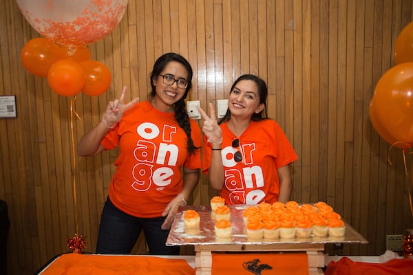 Isabella Hernandez, Graphic Designer and Stephania Ortega, Account Executive showing V's up on UTRGV Day.