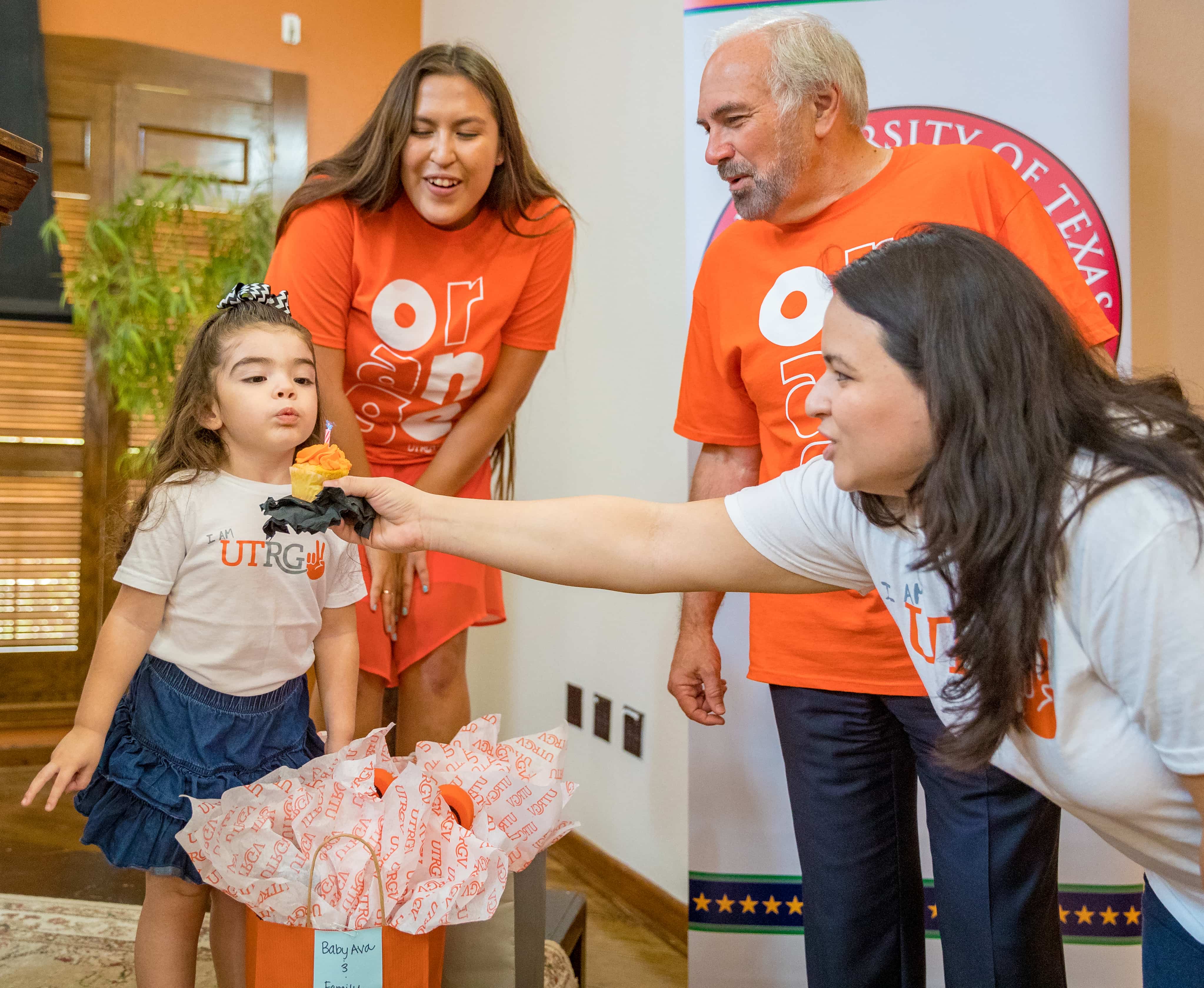 Ava Chambers, Future Vaquera blowing a candle on a cupcake.