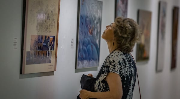 Visitor admiring a piece of art at the International Exhibition of Design and Illustration.