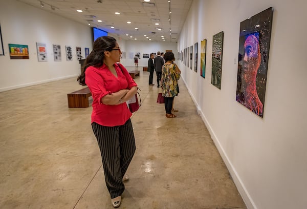 Female looking at art exhibit.