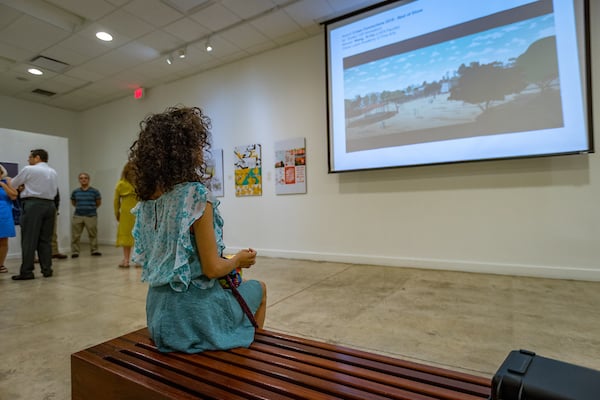 Brownsville Museum of Fine Art visitor sitting on bench.