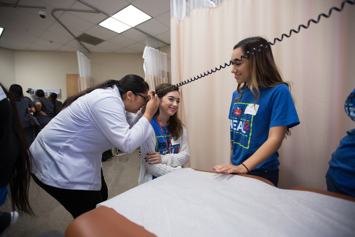 Taking a look at student’s ear.