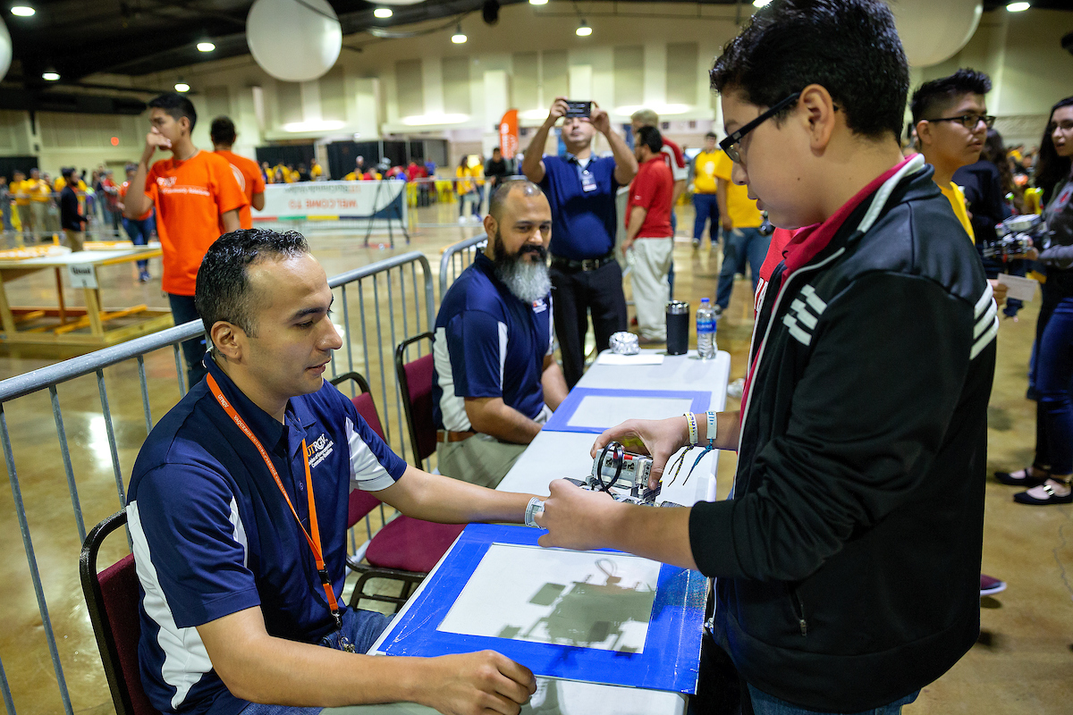 Judges inspect the robot before competition.