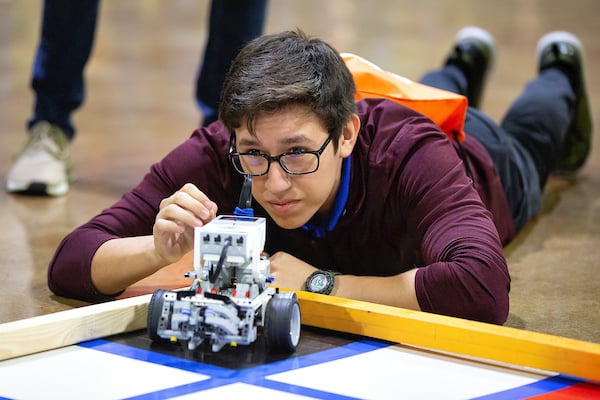 Student gets up close to start robot.