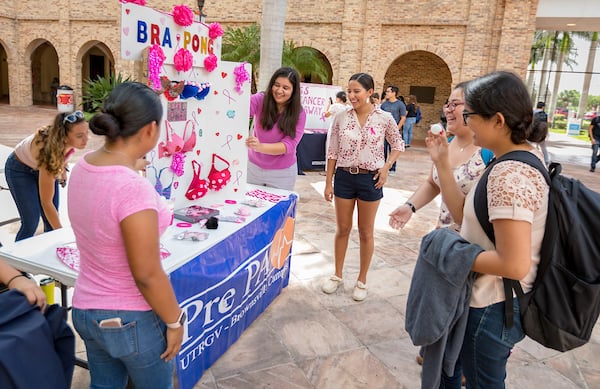 Students play bra pong during mini fair.