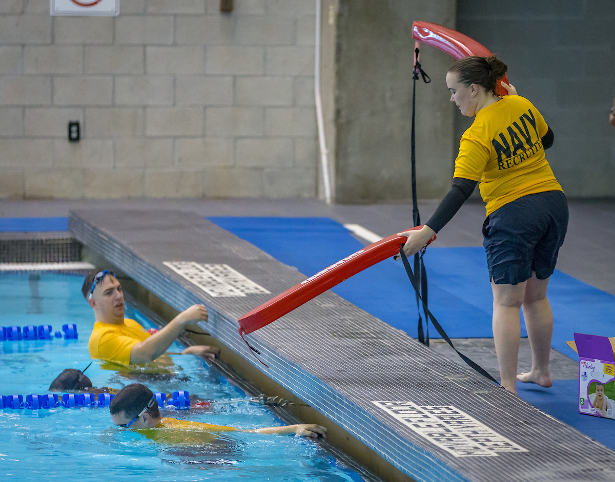 U.S. Navy members help prepare the course.