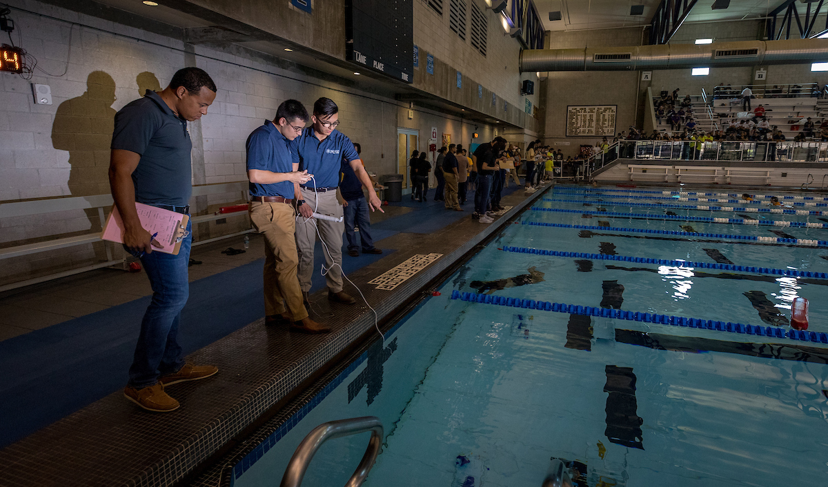 A judge checks out the team’s robot.